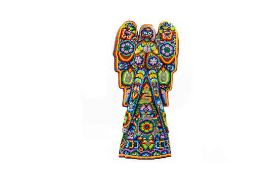 Vibrant Huichol bead art of an angel sculpture standing frontally, adorned with multicolored patterns and spiritual symbols, handcrafted with precision, against a white background