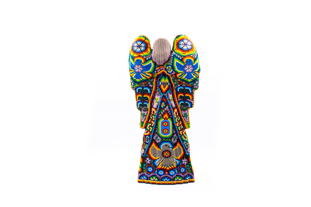 Intricately beaded Huichol angel artwork viewed from behind, showcasing detailed geometric patterns and native iconography in a kaleidoscope of colors, isolated on whit
