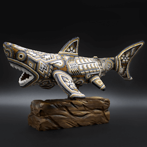 Shark sculpture with gold-colored beads on a wooden base