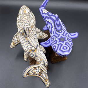 Shark sculptures with beads on wooden bases